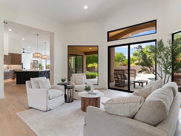 Comfortable living area with expansive backyard views, oversized glass doors, and abundant natural light. Designed for effortless entertaining and easy access to the outdoor living spaces.