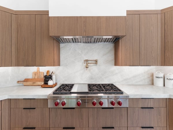 Professional-grade Wolf gas cooktop highlighted by sleek quartz countertops, custom cabinetry, designer backsplash, and premium finishes. A chef-inspired centerpiece for this beautifully remodeled Scottsdale home.