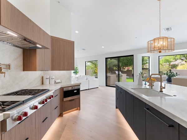 Expansive quartz island anchors this luxurious kitchen featuring premium appliances, custom cabinetry, designer finishes, and an open floor plan ideal for gathering with family and friends.