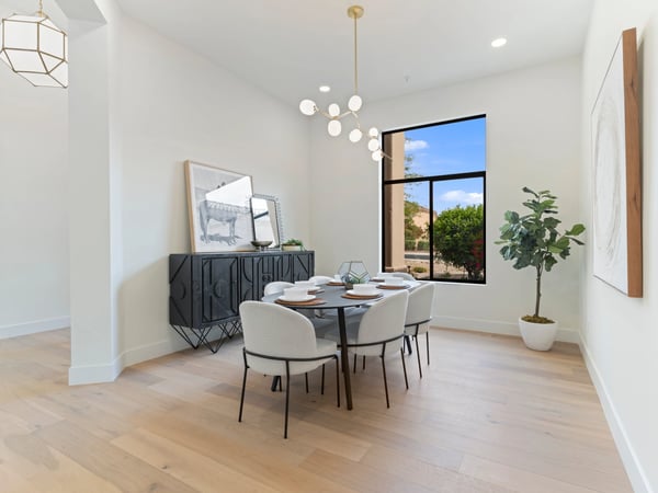 Elegant dining room showcasing modern lighting, oversized windows, and refined finishes that complement the home's contemporary design. A welcoming space for memorable dinners and entertaining in this luxury Scottsdale residence.