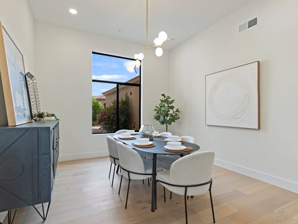 Sophisticated dining space with abundant natural light, stylish fixtures, and an open, airy feel. Designed to blend seamlessly with the home's modern layout while offering the perfect setting for gatherings.