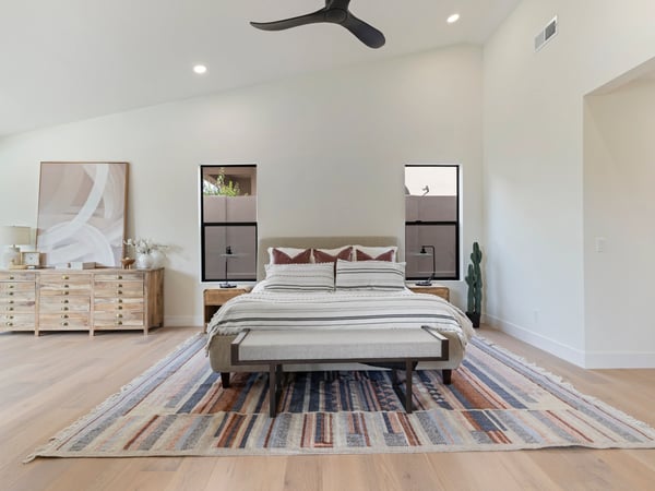 Elegant primary bedroom offering expansive living space, vaulted ceilings, oversized windows, and modern finishes. A peaceful retreat designed with style and functionality in mind.