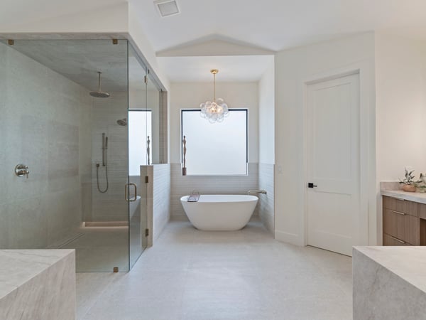 Beautifully designed primary bathroom with a freestanding soaking tub, expansive walk-in shower, custom cabinetry, and premium finishes. Spa-inspired luxury enhances everyday living.