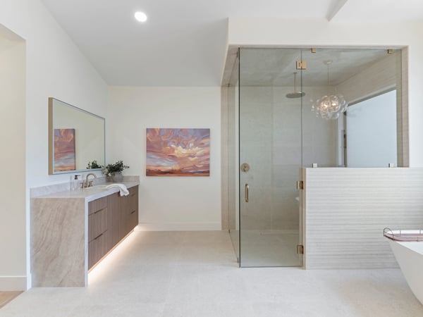 Contemporary walk-in shower featuring frameless glass, elegant tilework, rainfall fixtures, and spacious design. Luxury details elevate this exceptional Scottsdale home's primary bath.