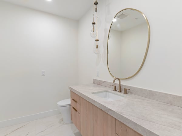 Elegant guest bathroom with quartz counters, custom cabinetry, designer lighting, and upscale hardware. Every detail reflects the exceptional craftsmanship found throughout this Scottsdale residence.