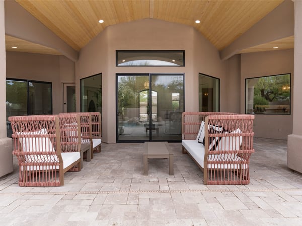 Spacious covered patio with wood-accent ceiling, comfortable seating, and direct access to the pool area. Ideal for enjoying Scottsdale's indoor-outdoor lifestyle.