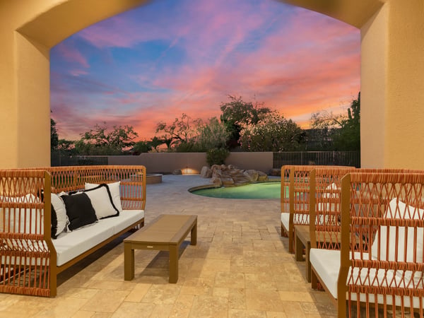 Relax beneath the covered patio while enjoying colorful Scottsdale sunsets overlooking the sparkling pool, fire feature, and beautifully landscaped backyard retreat.