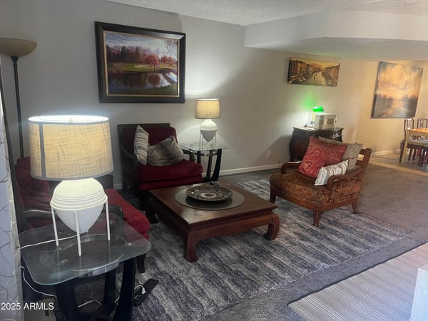 Inviting family room showcases neutral colors, plush carpeting, and flexible living space designed for relaxing with family or entertaining friends.