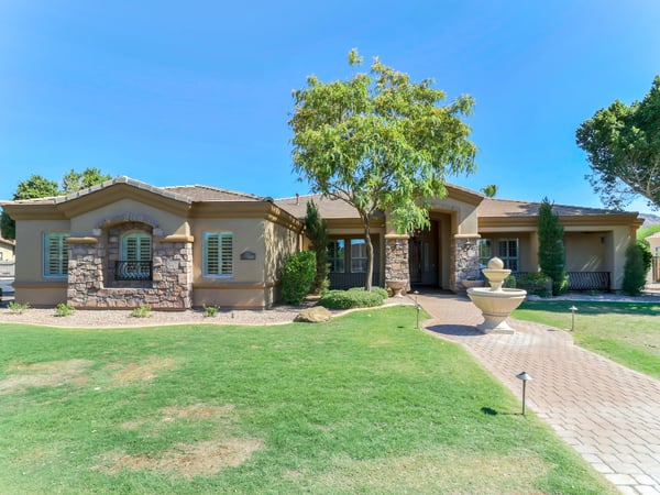 The attractive front elevation features stone architectural details, lush landscaping, a paver walkway, and an inviting covered entry. Exceptional curb appeal welcomes you to this beautiful home in Glendale.