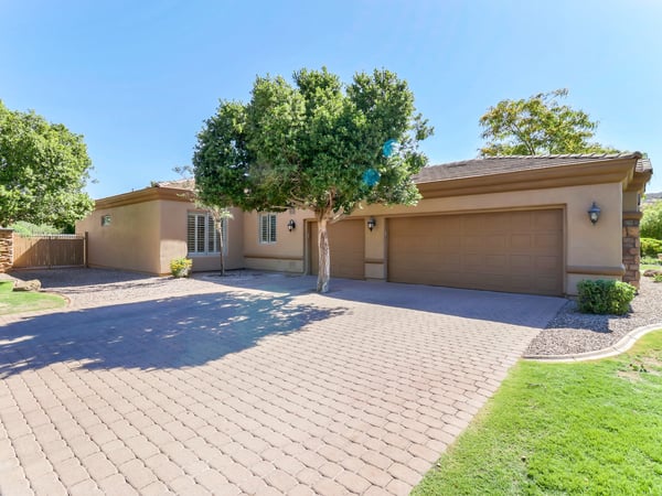 Attractive paver driveway complements the extended-length attached 3-car garage with built-in storage cabinets and direct home access. The generous parking and side vehicle entry enhance both convenience and curb appeal.
