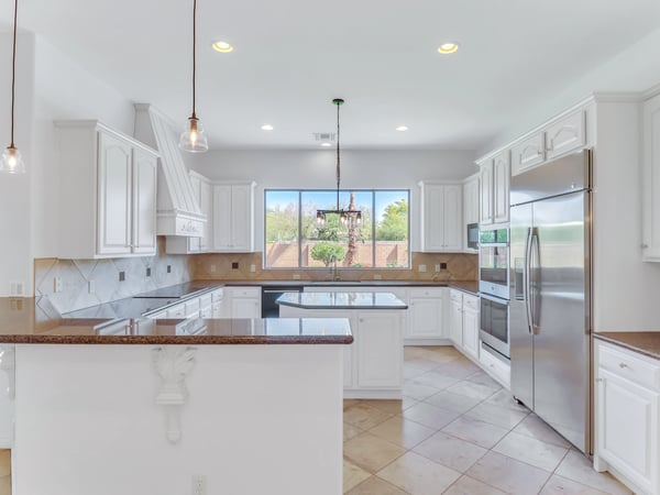 Beautiful kitchen with granite countertops, custom cabinetry, stainless steel appliances, center island, and abundant workspace. Thoughtfully designed for cooking, entertaining, and gathering with family and friends.