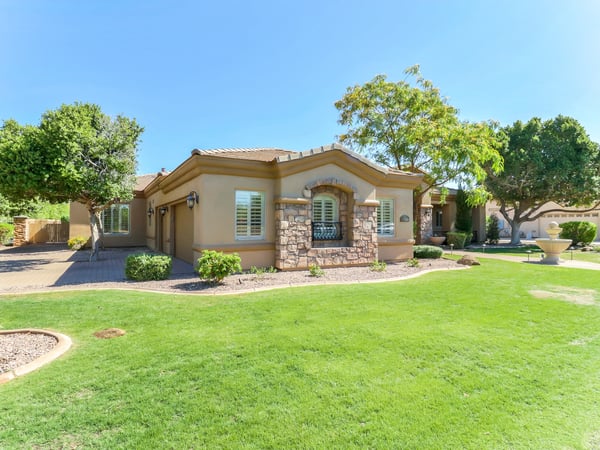 Beautiful stone detailing, mature landscaping, plantation shutters, and an inviting front entrance create outstanding curb appeal. This elegant Glendale residence offers timeless architecture and exceptional first impressions.
