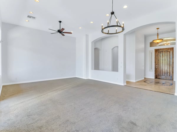 Soaring ceilings, elegant lighting, recessed lights, plush carpeting, and decorative archways create a bright and inviting formal living space. This Glendale home offers an open design perfect for entertaining.