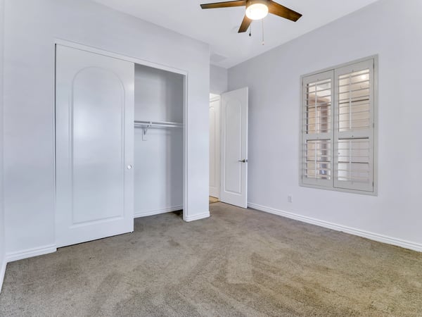 Well-appointed bedroom with generous closet space, plantation shutters, soft carpeting, and neutral d cor. This Glendale property provides comfortable space for guests, family, or a home office.