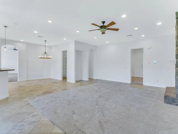 Open-concept living area with soaring ceilings, recessed lighting, plush carpeting, and seamless access to the dining and kitchen spaces. This Glendale home is ideal for entertaining and everyday comfort.