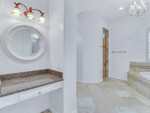 Dedicated vanity area with granite countertops, decorative mirror, upgraded lighting, and easy access to the luxurious primary bath. Thoughtfully designed for everyday comfort in this beautiful Glendale residence.