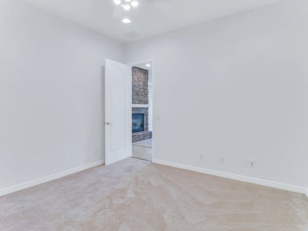 Bright bonus room featuring soft carpeting, ceiling fan, and neutral finishes. This adaptable Glendale home provides valuable extra space for work, hobbies, or overnight guests.