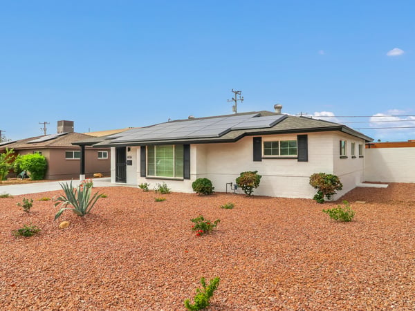 Attractive remodeled mid-century ranch home featuring fresh landscaping, modern exterior finishes, and a high-efficiency 36-panel solar system. This Phoenix rental offers outstanding curb appeal and reduced energy costs.