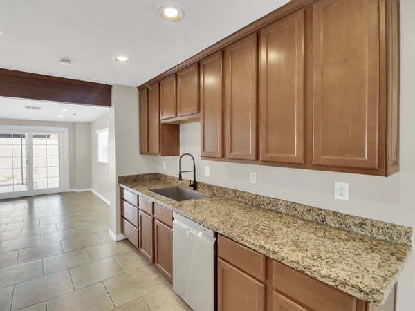 Spacious kitchen workspace featuring abundant cabinetry, granite countertops, modern fixtures, and generous prep space designed for convenient daily living and entertaining in this updated Phoenix rental.