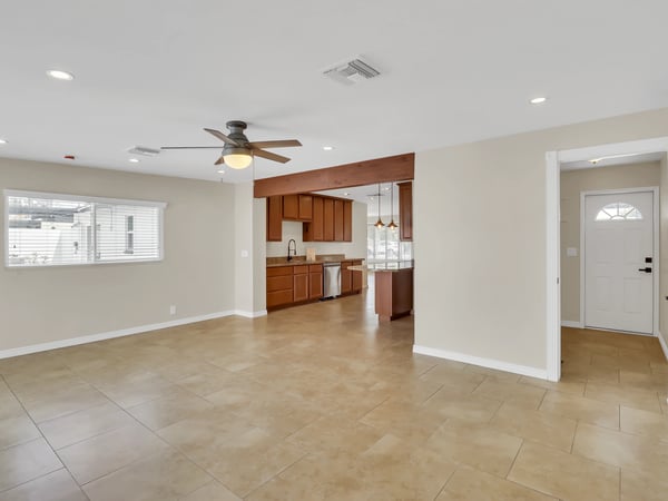 Spacious family room with oversized windows, modern finishes, and an open floor plan that flows effortlessly into the kitchen. This remodeled Phoenix rental is designed for comfortable everyday living.