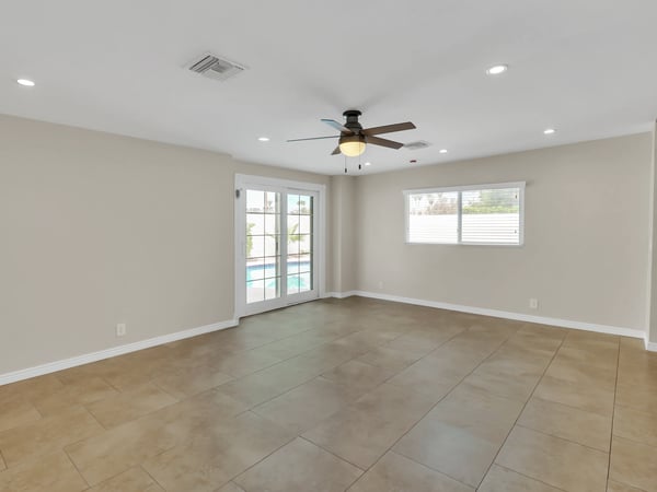 Bright family room with French doors leading to the private backyard and resurfaced pool, creating a seamless indoor-outdoor lifestyle. Enjoy comfortable living in this updated Phoenix rental.