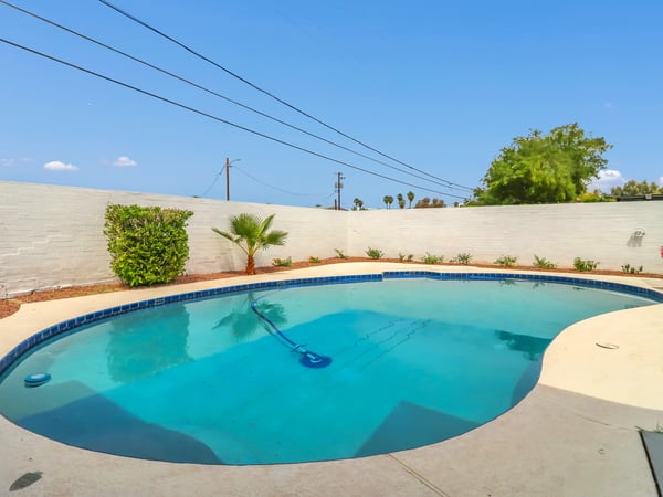 Private backyard pool surrounded by clean landscaping, block fencing, and plenty of sunshine for outdoor enjoyment. This desirable amenity adds comfort and value to this move-in-ready Phoenix rental.