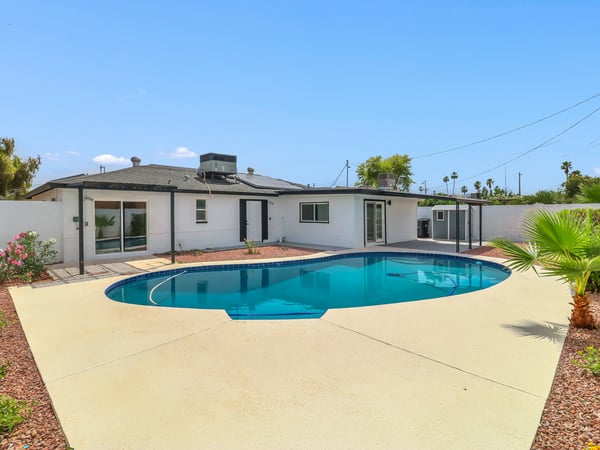 Relax in this fully fenced backyard complete with a sparkling pool, multiple covered patio areas, decorative desert landscaping, and storage shed. This impressive outdoor retreat perfectly complements the updated interior of this Phoenix rental.