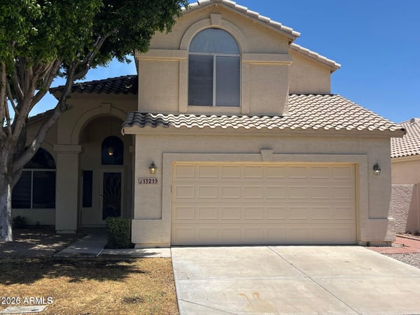 Beautifully maintained exterior with attractive architecture, mature shade trees, a covered front entry, and an attached 2-car garage in the sought-after Val Vista Lakes community in Gilbert.