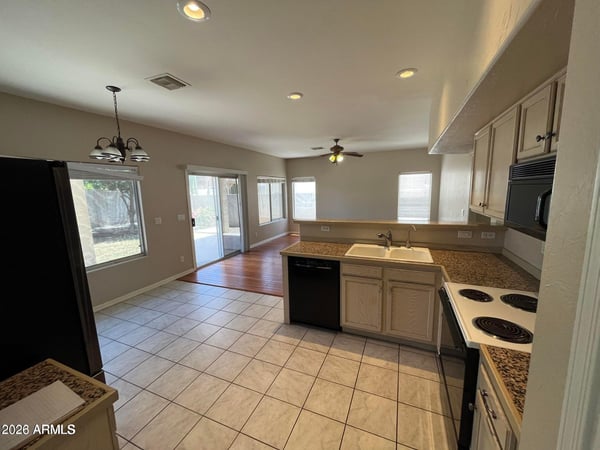 This bright kitchen connects seamlessly to the family room and covered patio, providing an ideal layout for entertaining while offering generous prep space and storage.