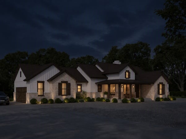 Modern home featuring unique architectural details, expansive outdoor space, and inviting nighttime ambiance in a quiet neighborhood.