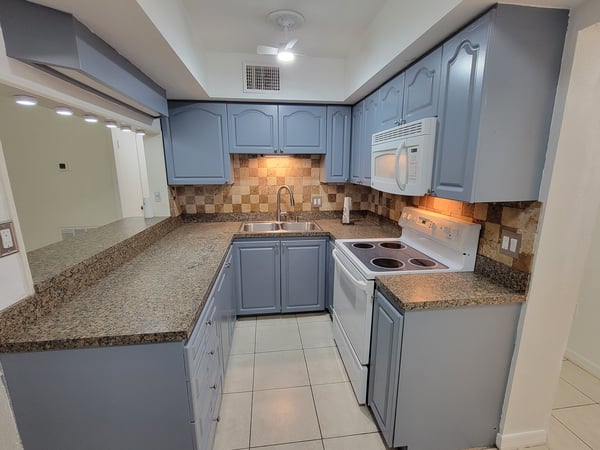 Modern kitchen featuring ample counter space, contemporary cabinetry, and updated appliances for convenient cooking.