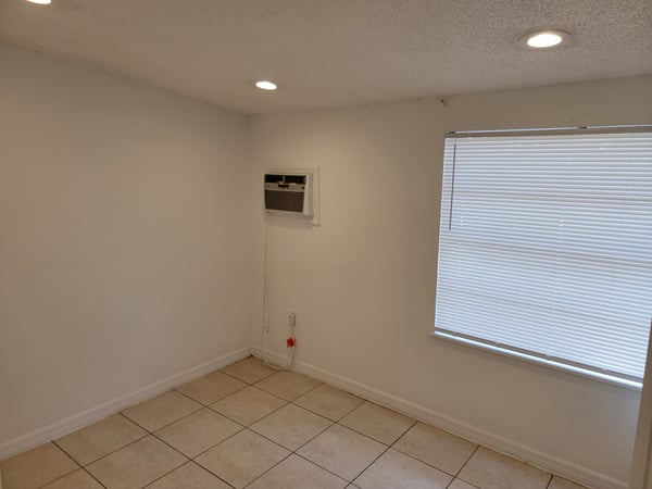 Bright, airy space featuring tile flooring and natural light, perfect for a cozy office or study.