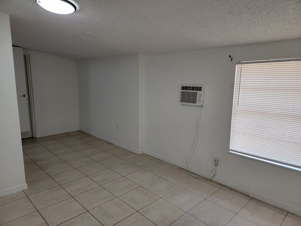 Spacious room with tile flooring and ample natural light, perfect for creating your ideal living space.
