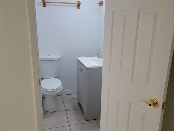 Bright bathroom featuring modern fixtures and ample space, conveniently accessible from the main living area.