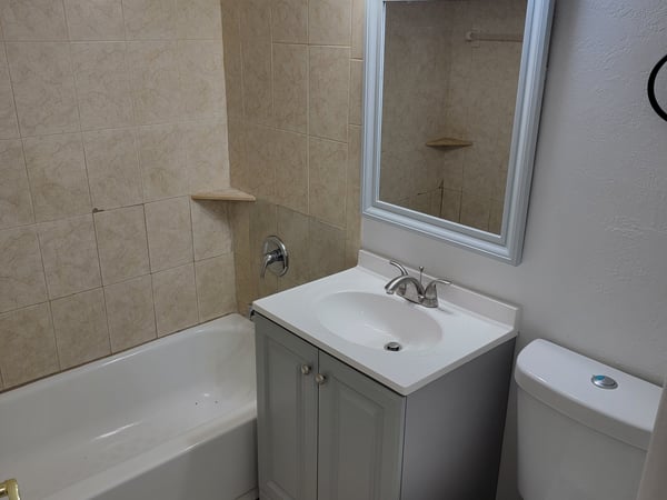 Bright bathroom featuring modern fixtures, tiled walls, and a clean design for a functional space.