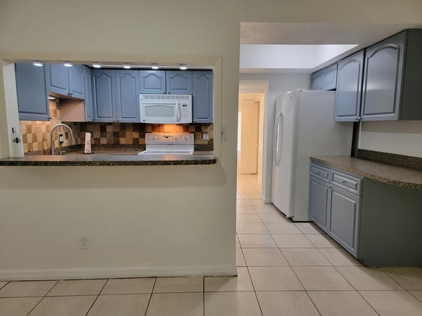 Bright kitchen featuring modern appliances and ample counter space, perfect for culinary enthusiasts.