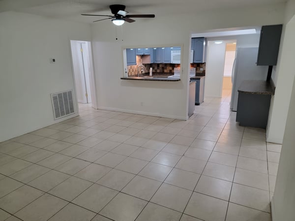 Bright and open living space featuring a seamlessly connected kitchen and ample room for entertaining.