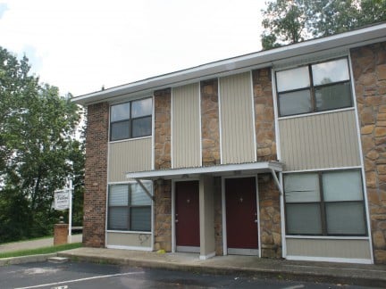 Spacious two-bedroom apartment featuring a unique stone facade and convenient parking just outside the entrance.