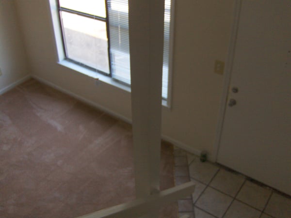 Bright open space with large windows and inviting flooring, perfect for personalizing your dream home.