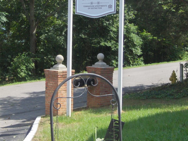 Discover the inviting entrance to Villas of Alabaster, featuring lush greenery and a welcoming atmosphere.