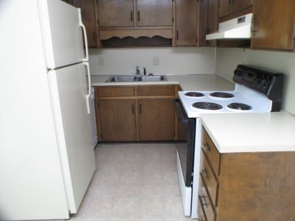 Cozy kitchen with essential appliances and ample cabinet space, perfect for everyday cooking needs.