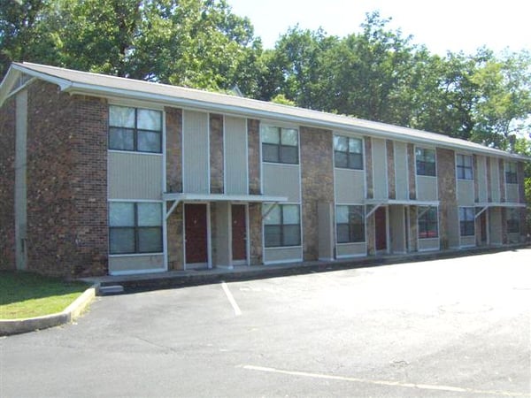 Well-maintained multi-unit building with ample parking and proximity to local amenities in a vibrant neighborhood.