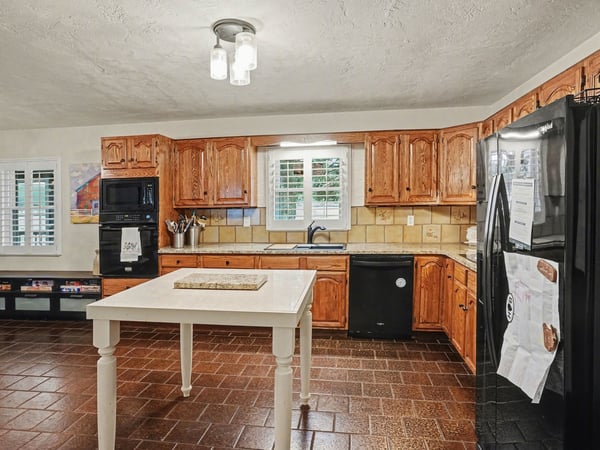 Kitchen with refinished real wood cabinets and new granite countertops.