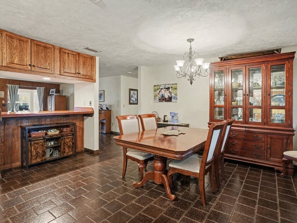 Dining area which can accommodate an eight-person table; the bar in the background opens to the Living Room.