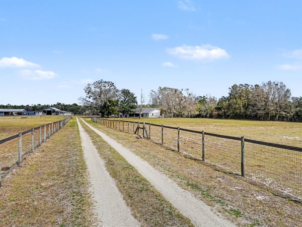 The private driveway boasts a solar-powered gate! Solar powered lighting lights the entry after dark.