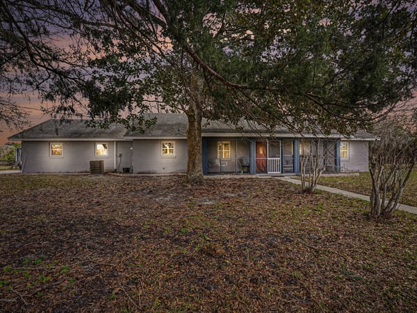 This 3 BR Ranch-style home features an abundance of natural wood and stone accents. Blending country charm with modern convenience, located close to beaches and shopping, this serene 5-acre setting encourages relaxation and creativity.