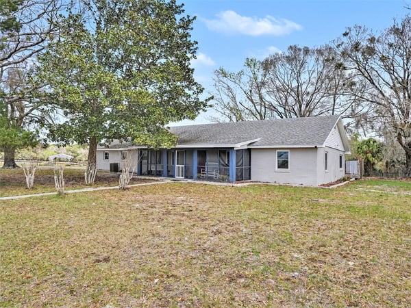 The front porch looks out across a picturesque field with mature trees, where you'll relax at the end of the day, soaking in the suns final rays. This photo also includes the southwest corner of the house. The sun rises behind the house, just off the Bonus Room and back deck. An added feature of the front porch sitting area is the screen enclosure along with the newly replaced screen door.