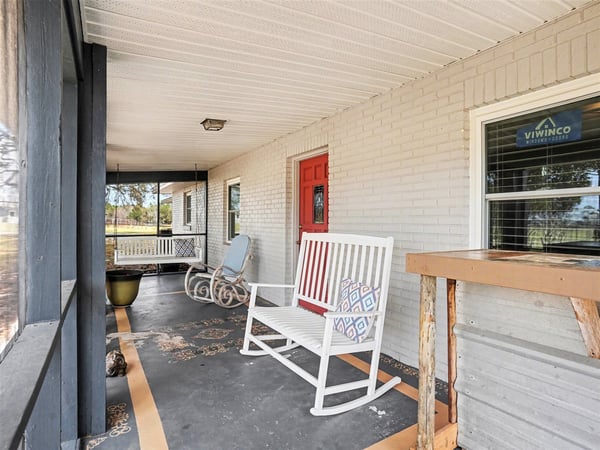 View of the Front Porch, which is fully screened to enjoy an evening drink all while taking in that immaculate Florida sunset!