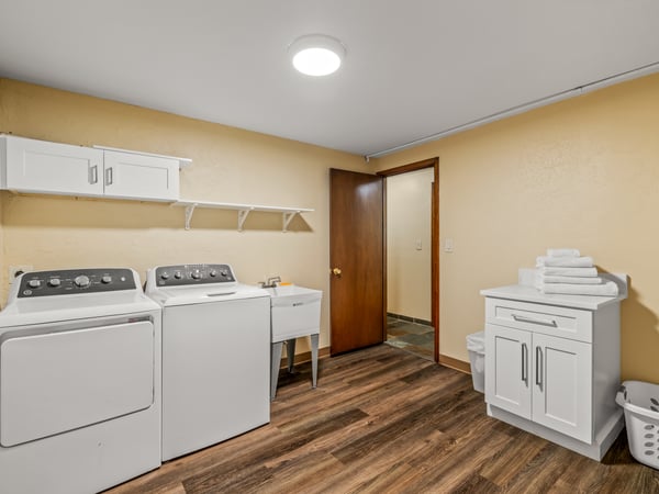 Large Laundry Room With Folding Area and Laundry Sink