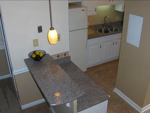 Bright kitchen featuring modern appliances, ample counter space, and a cozy breakfast bar for casual dining.
